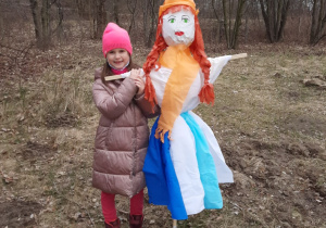 Uczennica klasy pierwszej pozuje do zdjęcia z Marzanną.